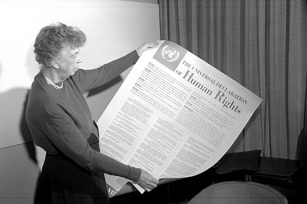 ELEANOR ROOSEVELT of the United States holding a poster of the Universal Declaration of Human Rights. Lake Success, NY, November . 1949. UN Photo