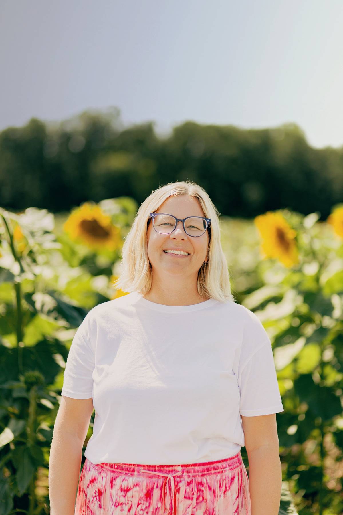 Sarah Deckert standing in front of sunflower field