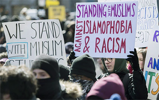 People hold signs during a demonstration in Montréal in March 2017 in support of Parliament’s motion to condemn Islamophobia, systemic racism and religious discrimination. THE CANADIAN PRESS/Graham Hughes