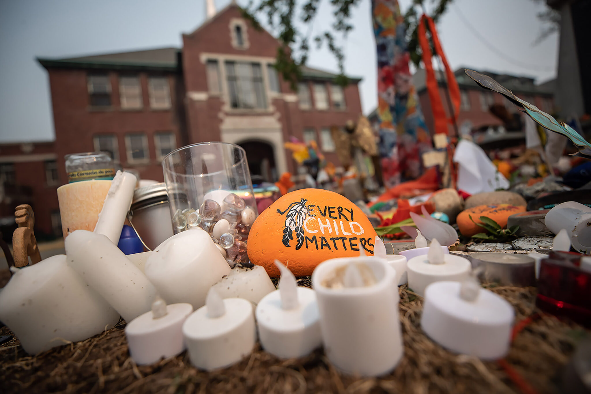 A rock with the message “Every Child Matters” painted on it sits at a memorial outside the former Kamloops Indian Residential School, in Kamloops, B.C., on Thursday, July 15, 2021. THE CANADIAN PRESS/Darryl Dyck.