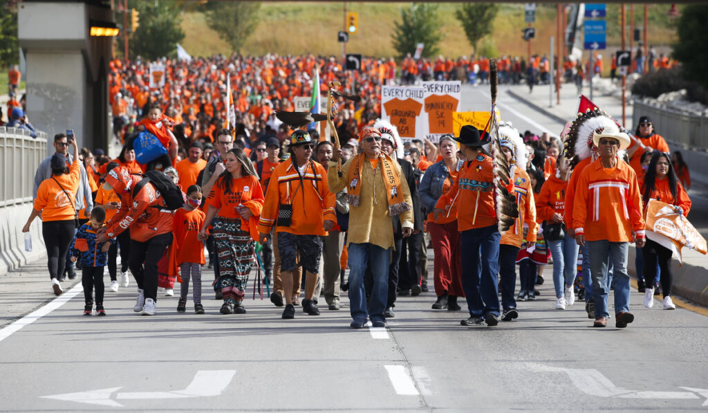 People attend the second annual Orange Shirt Day Survivors Walk and Pow Wow on National Day for Truth and Reconciliation in Winnipeg, September 30, 2022. Image: John Woods, The Canadian Press