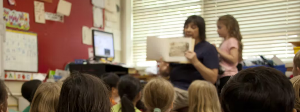 Blurred Image of educator reading to children