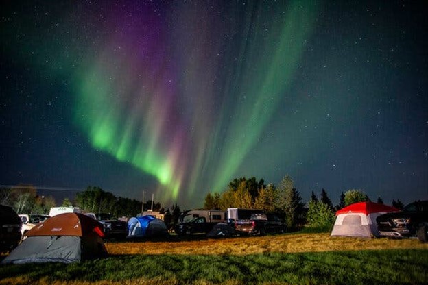 Image of evacuee tents under the northen lights.